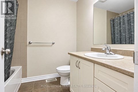 A bathroom with a toilet, sink, and shower.