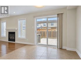 A spacious living room with a fireplace and sliding glass doors leading to a deck.