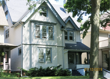 A house with a blue and white exterior is shown.