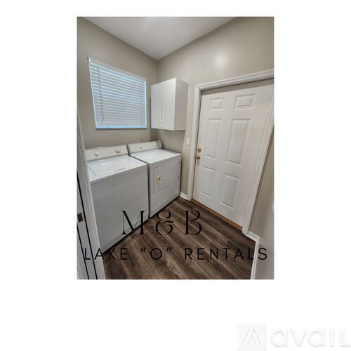 A bedroom with two beds and a door.