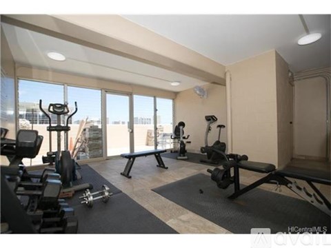 A gym with a view of the city outside the window.