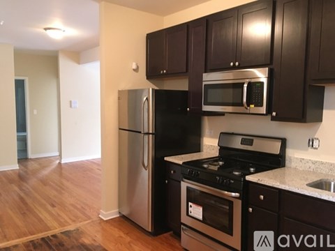 A kitchen with black cabinets and stainless steel appliances.