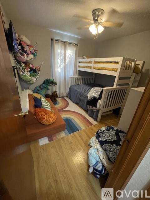 A room with a bunk bed and a dresser with a shoe rack.