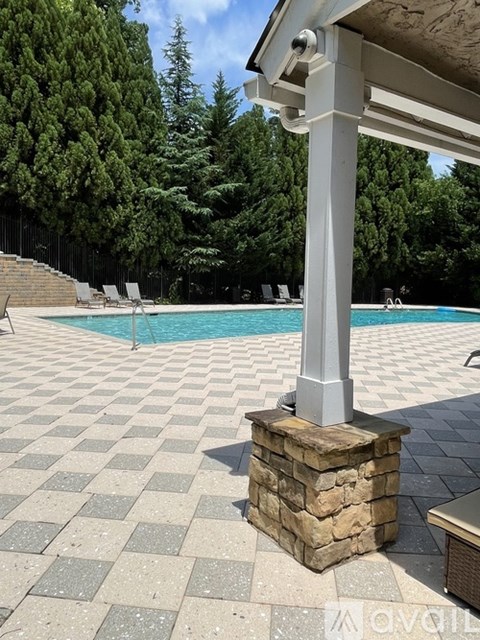 A pool with a tiled floor and a pillar.