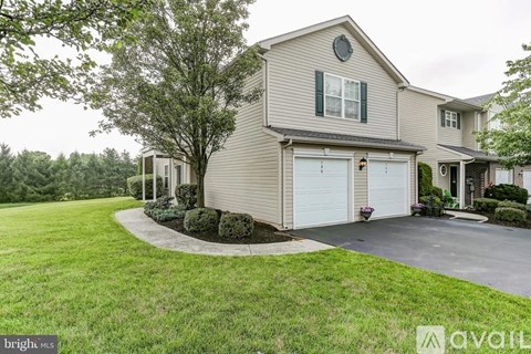 A house with a garage is for sale.