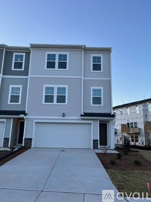 A two-story residential building with a garage door.