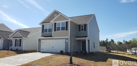 A house with a garage is for sale.