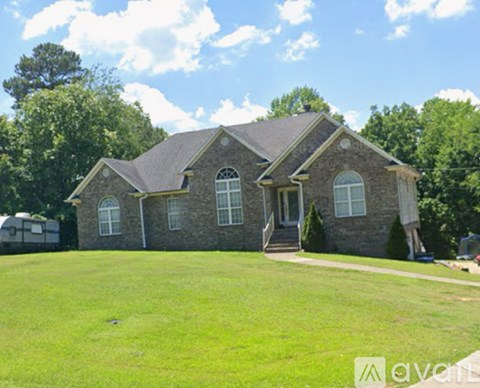 A house with a large front yard is for sale.
