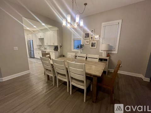 A dining room with a table and chairs.