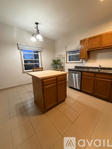 A kitchen with wooden cabinets and a white countertop.