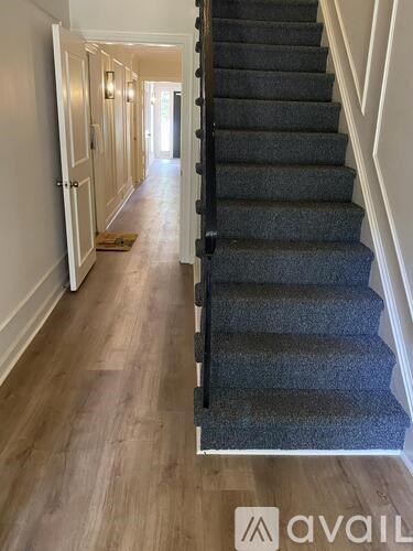 A long hallway with a staircase on the right.