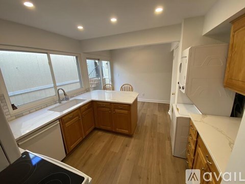 A kitchen with wooden cabinets and a white countertop.