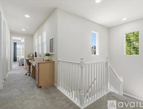 A spacious room with a desk and a window.