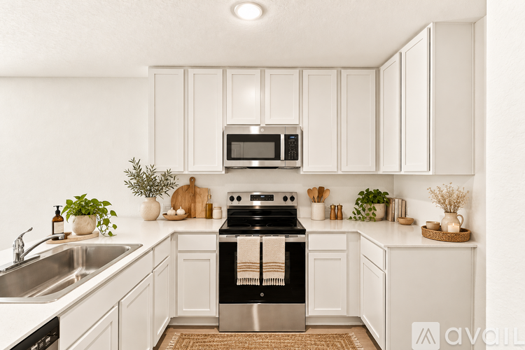 A modern kitchen with white cabinets and a black oven.