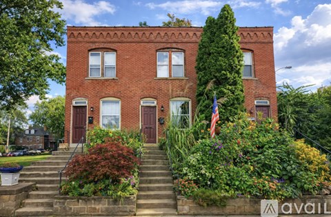A red brick building with a flag on the front.