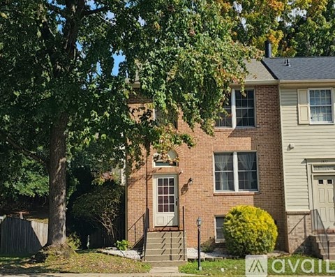 A house with a tree in front of it.
