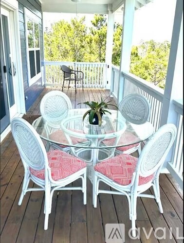 A patio with a glass table and chairs.