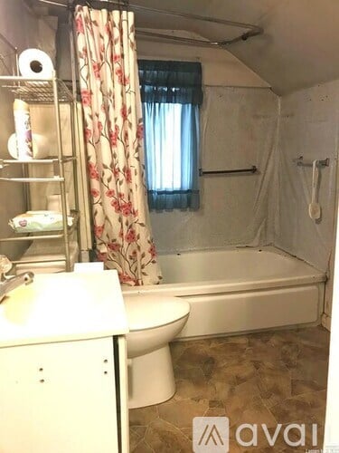 A small bathroom with a toilet, sink, and bathtub.