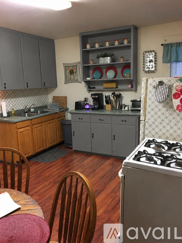 A kitchen with a wooden table and chairs.