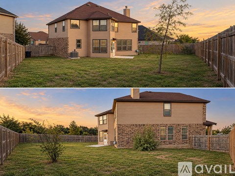 Two houses with a fence in front of them.