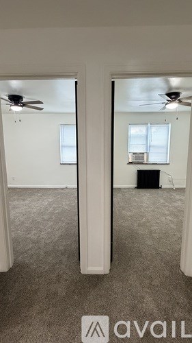 A room with a ceiling fan and a window.