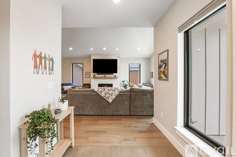 A living room with a grey couch and a television.