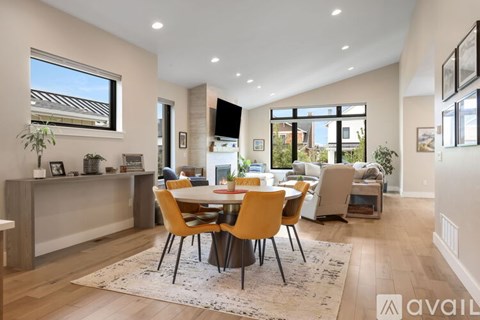 A modern dining room with a large table and chairs.