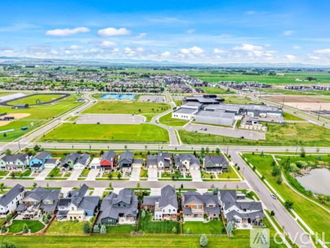 A suburban neighborhood with a mix of single-family homes and a large commercial building.