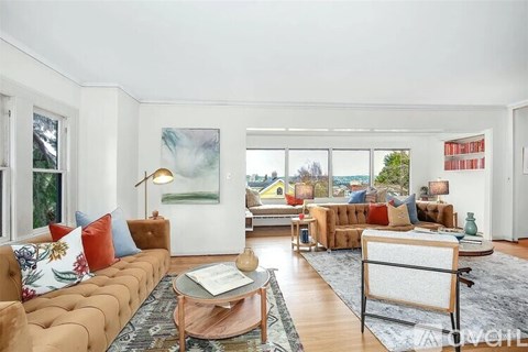 A living room with a brown sofa and a coffee table.