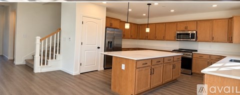 A kitchen with wooden cabinets and a white countertop.