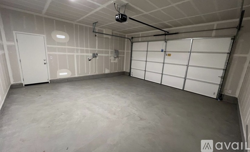 A spacious garage with white walls and a concrete floor.