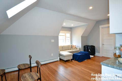 A living room with a couch and a chair.