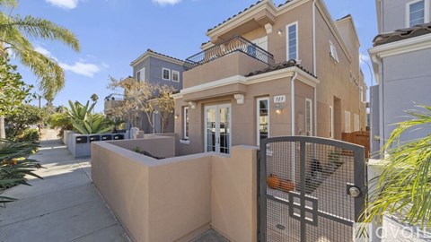 A house with a gate and a wall in front of it.