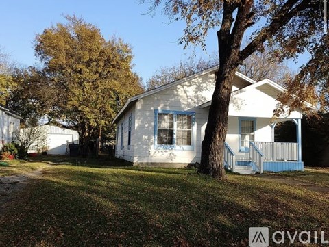 A house with a blue front porch is for sale.