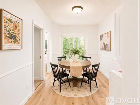 A dining room with a table set for four.