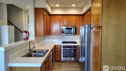 A kitchen with wooden cabinets and stainless steel appliances.