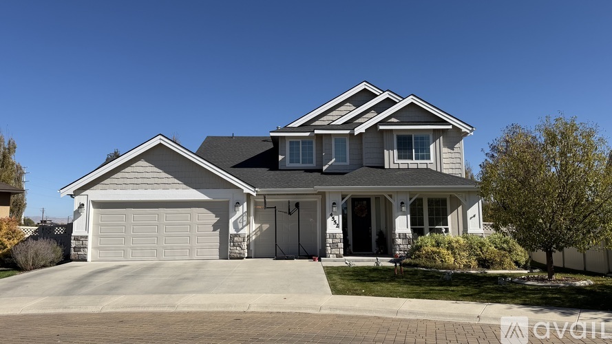 A two-story house with a garage is available for sale.