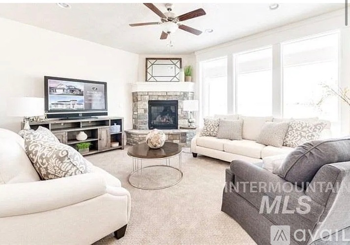A living room with a fireplace and a television.