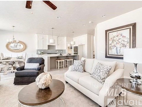 A living room with a white couch and a coffee table.