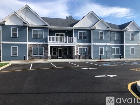 A large building with a parking lot in front of it.