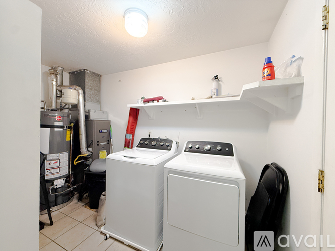 A small laundry room with two front loading washing machines.