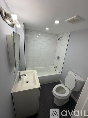 A white sink and toilet in a small bathroom.