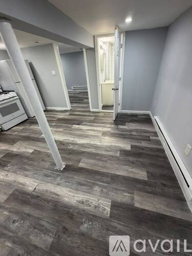 A room with grey walls and a wooden floor.