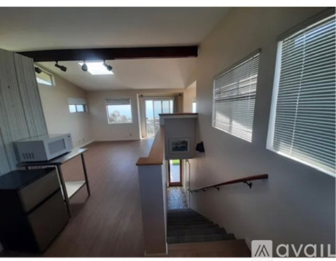 A kitchen with a microwave, stove, and oven.