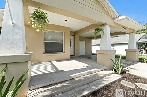 A house with a beige exterior and a covered patio area.