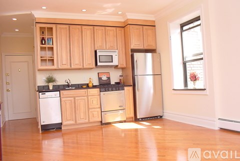 A kitchen with wooden cabinets and stainless steel appliances.