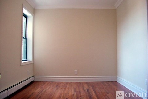 A room with wooden floors and a window.