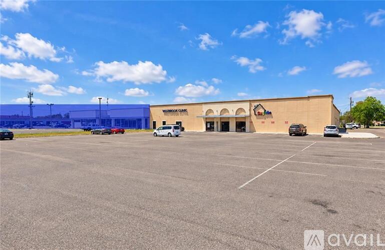 A large building with the words "Medical Center" on it is surrounded by a parking lot.