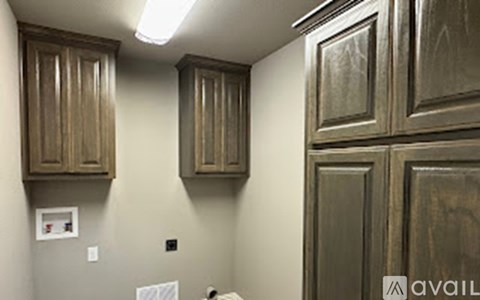 A kitchen with wooden cabinets and a white fridge.