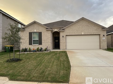 A house with a garage and a driveway in front.